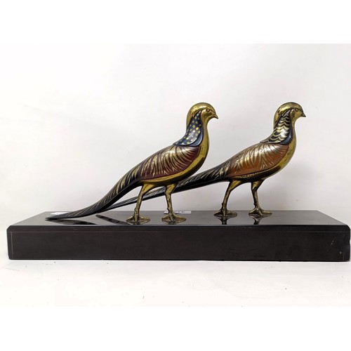 414 - A pair of painted silver coloured metal pheasants, on a marble base, 40 cm wide