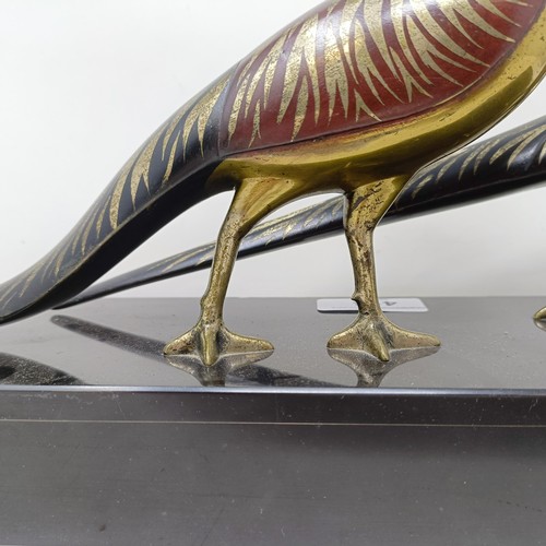 414 - A pair of painted silver coloured metal pheasants, on a marble base, 40 cm wide