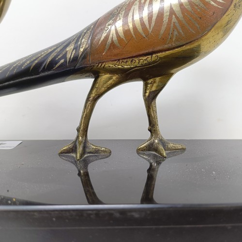 414 - A pair of painted silver coloured metal pheasants, on a marble base, 40 cm wide