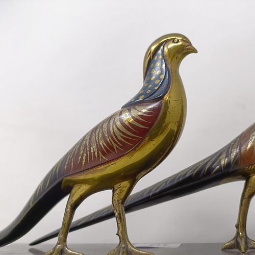 414 - A pair of painted silver coloured metal pheasants, on a marble base, 40 cm wide