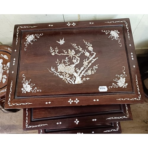 715 - A nest of four Chinese occasional tables, inlaid with mother of pearl, the largest 50.5 cm wide