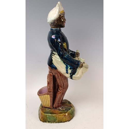 531 - A majolica style figure of a chef, 42 cm high