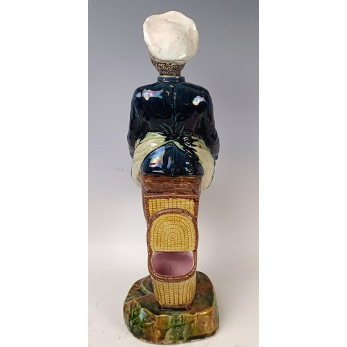 531 - A majolica style figure of a chef, 42 cm high