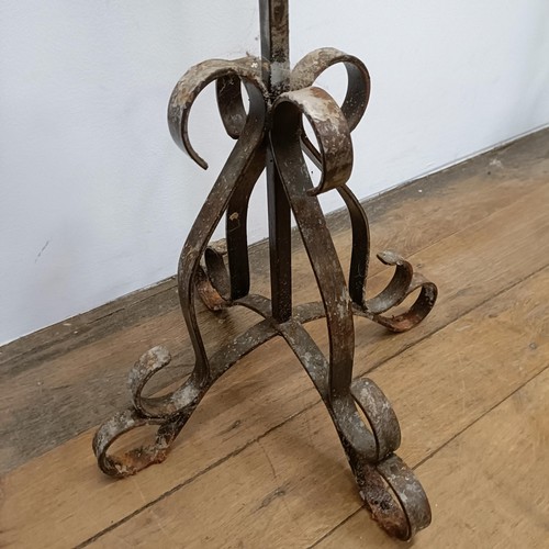 635 - A pair of wrought iron standard pricket candle stands, 164 cm high