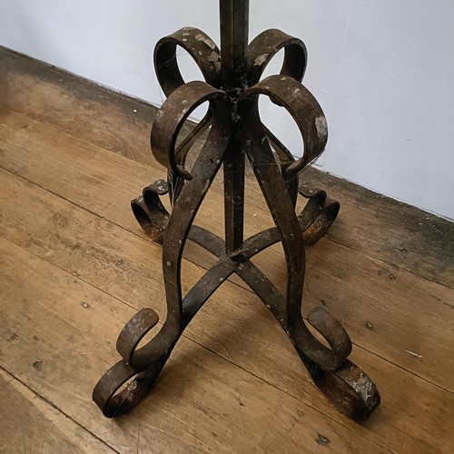 635 - A pair of wrought iron standard pricket candle stands, 164 cm high