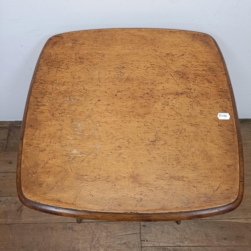 681 - A 1920s maple lamp table, 61 cm wide