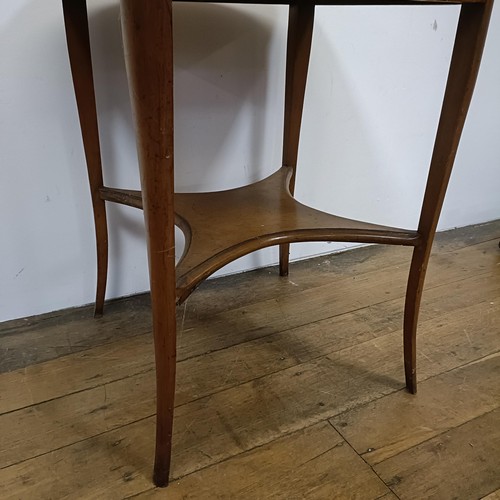 681 - A 1920s maple lamp table, 61 cm wide