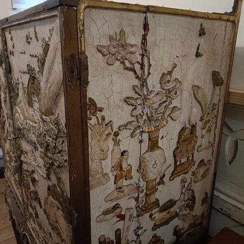 688 - A Chinese style drinks cabinet, the sides inset with plaster relief decorated landscapes, with two d... 