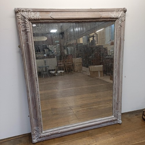 697 - A large limed oak framed wall mirror, 163 x 132 cm