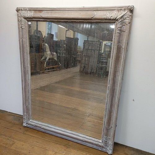 697 - A large limed oak framed wall mirror, 163 x 132 cm