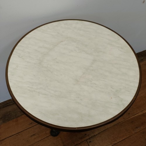 707 - A pair of marble topped garden tables, on tripod bases, 60 cm diameter