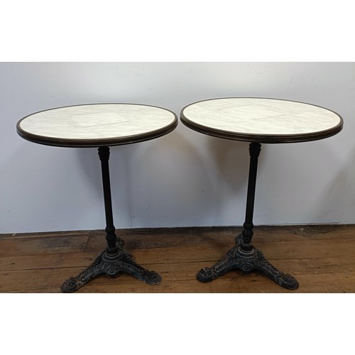 707 - A pair of marble topped garden tables, on tripod bases, 60 cm diameter