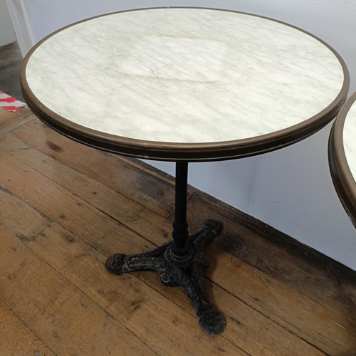 707 - A pair of marble topped garden tables, on tripod bases, 60 cm diameter