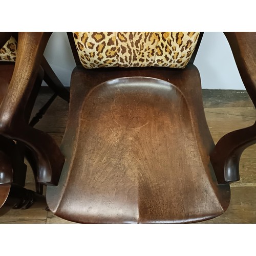 710 - A pair of 19th century mahogany desk chairs, with shaped seats and turned legs united by stretchers ... 