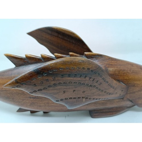 602 - A carved wood Pitcain Islands type fish, John Christian, 40 cm wide