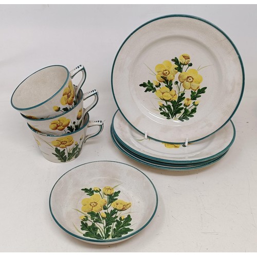 545 - A Wemyss cup and saucer, decorated buttercups, two matching cups and three plates