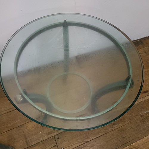 716 - A pair of glass top side tables, on metal bases, 60 cm diameter (2)