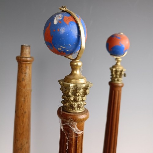 573 - A set of four Masonic type globes raised on pillars, 50 cm high, one lacking a globe (4)