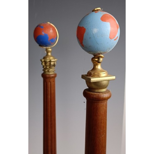 573 - A set of four Masonic type globes raised on pillars, 50 cm high, one lacking a globe (4)