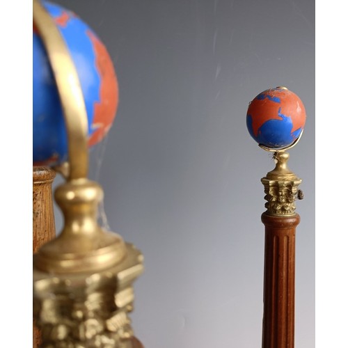 573 - A set of four Masonic type globes raised on pillars, 50 cm high, one lacking a globe (4)