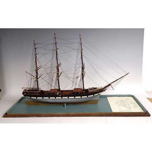 569 - A model of a three masted sailing ship, in a glass case, 74 cm wide