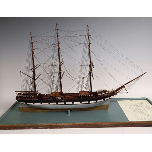 569 - A model of a three masted sailing ship, in a glass case, 74 cm wide