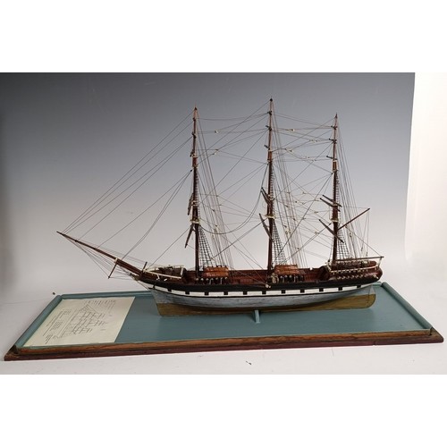 569 - A model of a three masted sailing ship, in a glass case, 74 cm wide