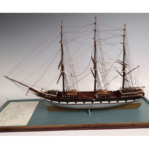 569 - A model of a three masted sailing ship, in a glass case, 74 cm wide