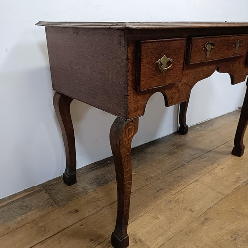 730 - An oak lowboy, having three drawers, 100 cm wide