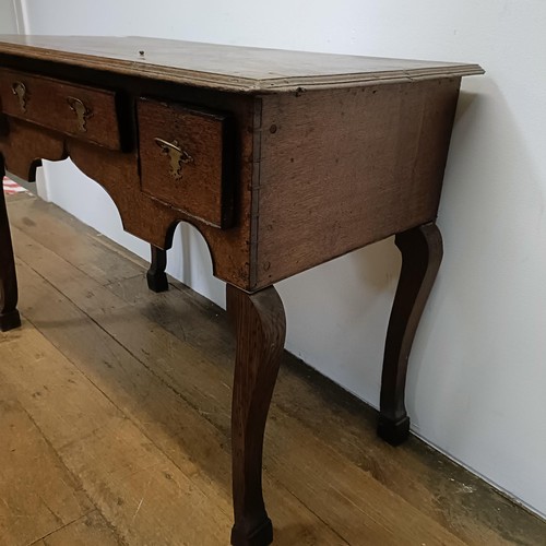 730 - An oak lowboy, having three drawers, 100 cm wide