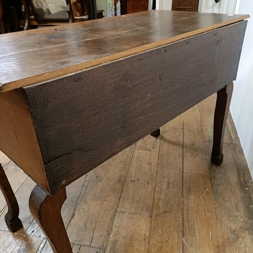 730 - An oak lowboy, having three drawers, 100 cm wide