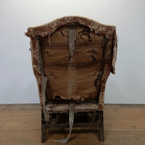 732 - A 19th century wing armchair, in need of restoration