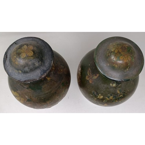 604 - A pair of papier mache painted urns, decorated flowers, 30 cm high