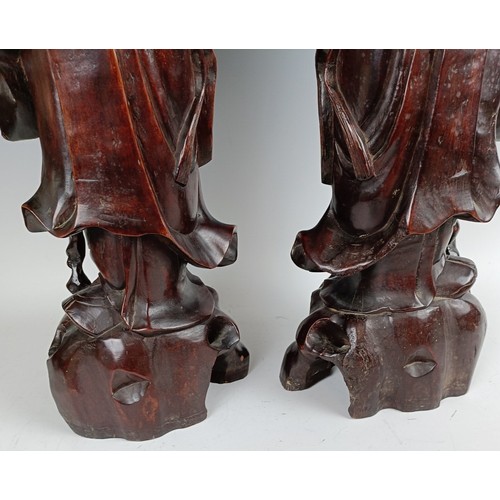 606 - A pair of Chinese carved figures, converted to lamp bases, 60 cm high (2)