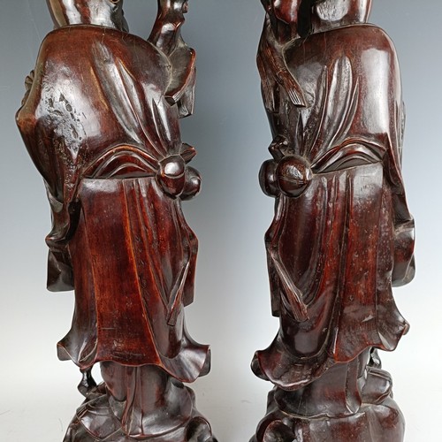 606 - A pair of Chinese carved figures, converted to lamp bases, 60 cm high (2)