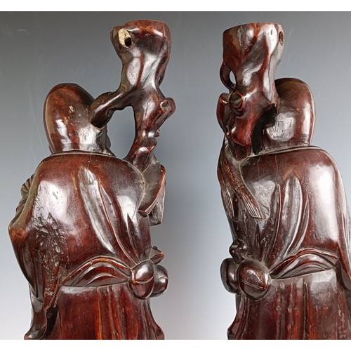 606 - A pair of Chinese carved figures, converted to lamp bases, 60 cm high (2)