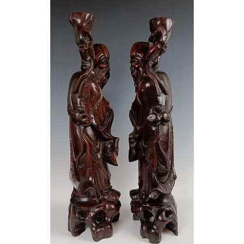 606 - A pair of Chinese carved figures, converted to lamp bases, 60 cm high (2)