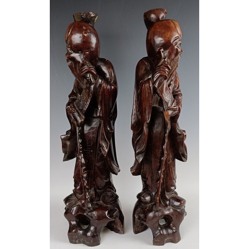 606 - A pair of Chinese carved figures, converted to lamp bases, 60 cm high (2)