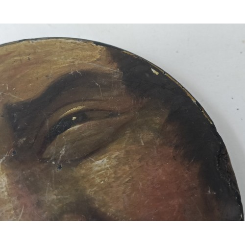 607 - A 19th century papier mache snuff box, the lid painted with face of a grotesque man, 11 cm diameter