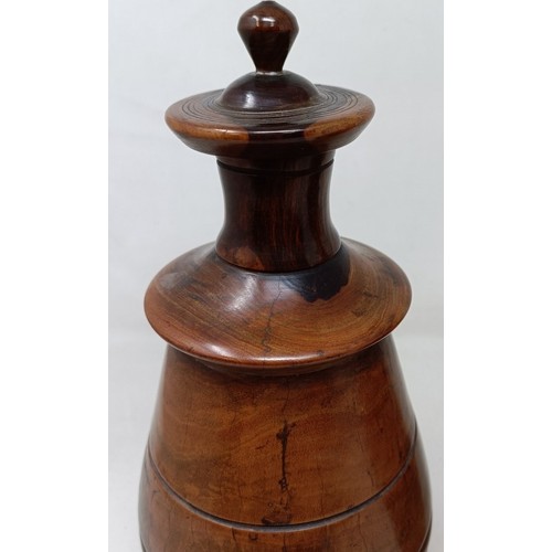 610 - A pair of turned lignum vitae urns and cover, 30 cm high (2)