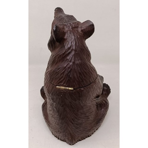 609 - A Black Forest style carved bear caddy, 22 cm high