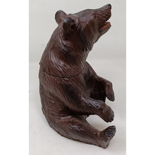 609 - A Black Forest style carved bear caddy, 22 cm high