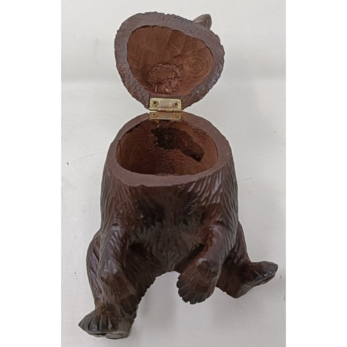 609 - A Black Forest style carved bear caddy, 22 cm high