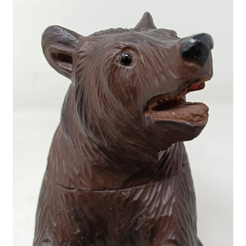 609 - A Black Forest style carved bear caddy, 22 cm high