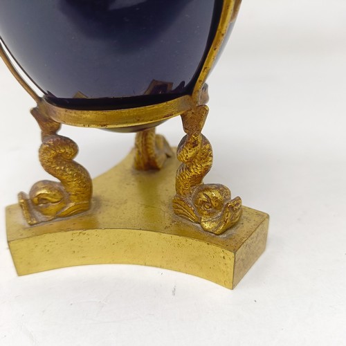 642 - A late 19th/early 20th century porcelain and gilt metal inkwell, 7 cm diameter