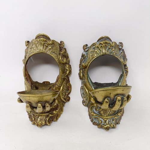 640 - A pair of unusual late 19th/early 20th century brass wall mounts, with drop down compartments in the... 