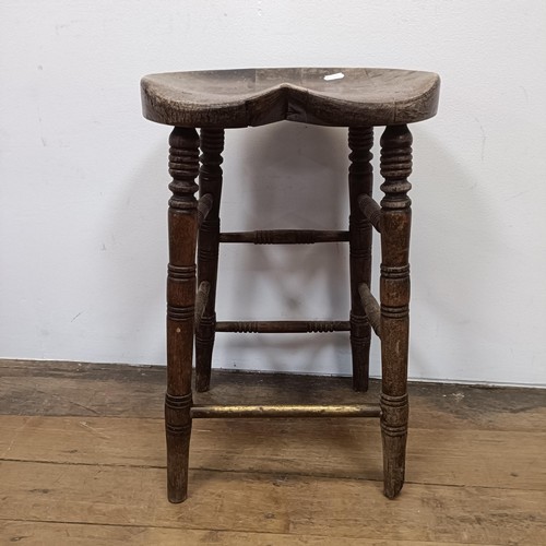 758 - A stool, with a shaped seat, on turned legs, 66 cm high