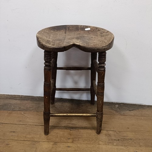 758 - A stool, with a shaped seat, on turned legs, 66 cm high