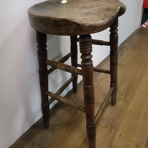 758 - A stool, with a shaped seat, on turned legs, 66 cm high