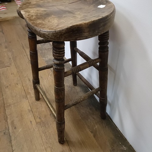 758 - A stool, with a shaped seat, on turned legs, 66 cm high